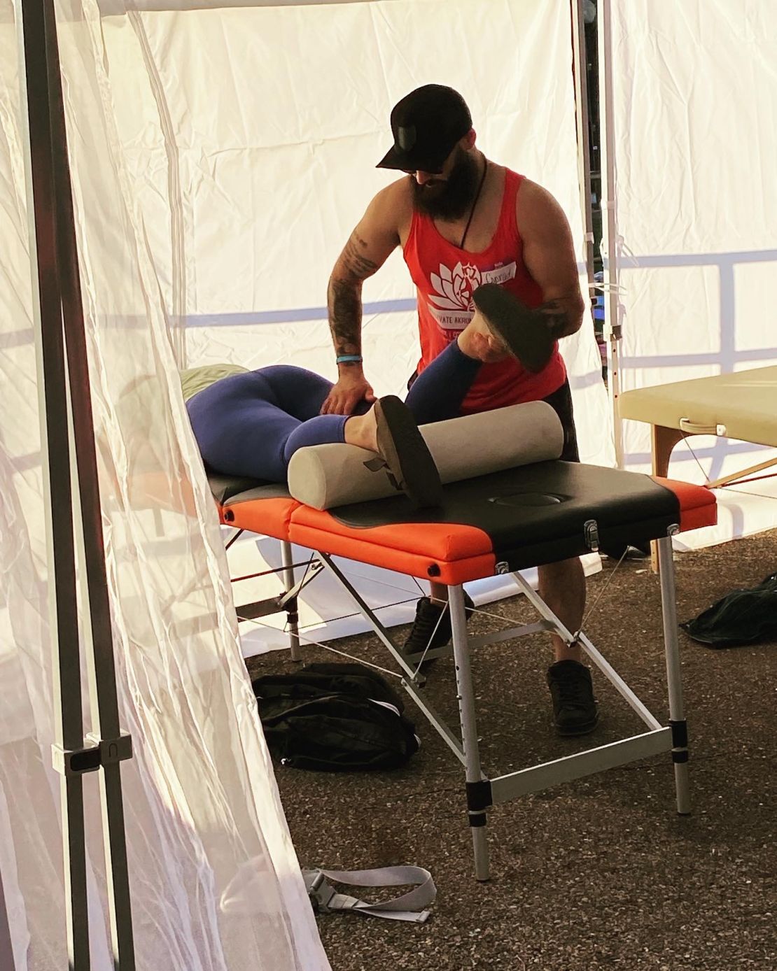 Conrad from Truly Heal Wellness providing sports massage and recovery therapy at Elevate Akron outdoor wellness eventâsupporting athletic performance and mobility